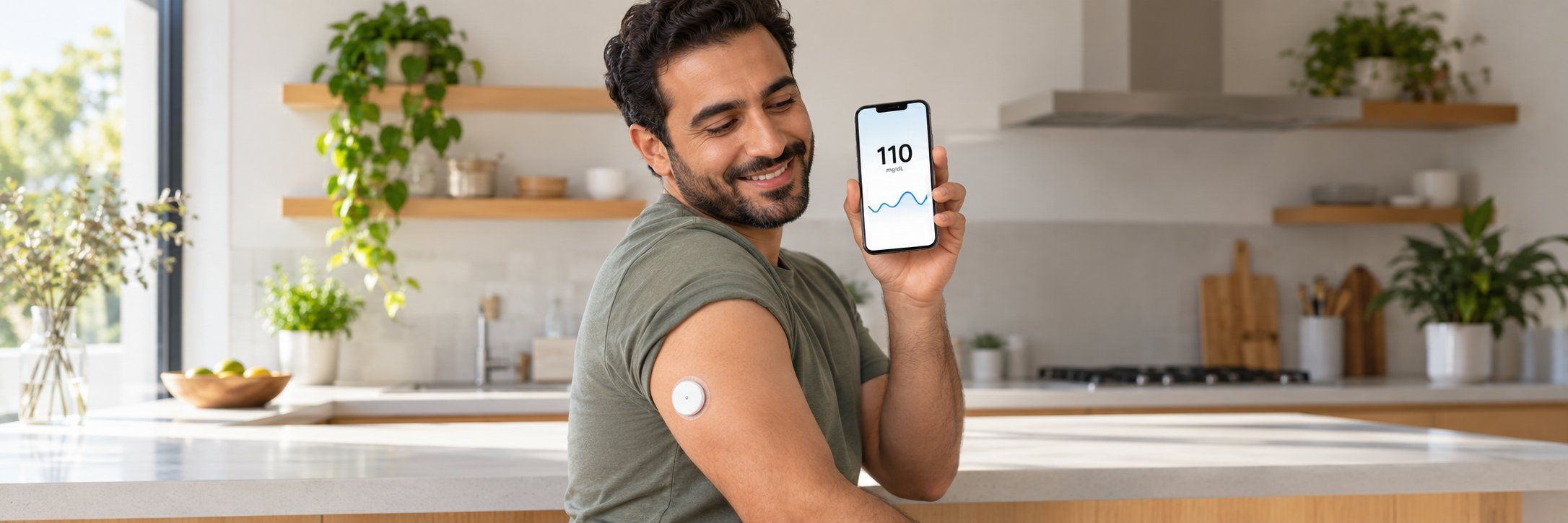 A man in his kitchen checking continuous glucose monitor readings on his phone